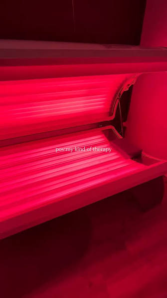 Red light therapy bed glowing red at Next Level Spa-lala